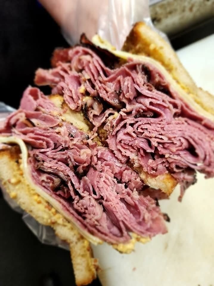 A mix of Carnegie Deli corned beef and pastrami, melted swiss cheese, delicatessen mustard, on toasted rye bread.